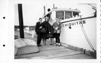 [Group photograph of four women beside the "Chiquita III"]