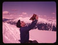 Jim MacDonald drinking from wine skin [Mount Price], Apr. 6, 1958