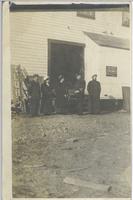 [Five people standing in front of a building in Stewart, B.C.]