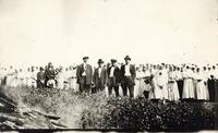 [Large group of Doukhobor men, women and children standing in an unknown location]
