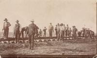 [Group portrait of Doukhobor men laying railroad tracks in an unknown location]