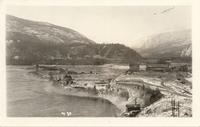 [View of a Doukhobor village and farm fields next to a river in an unknown location]