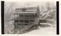[Snow-covered Doukhobor dwelling on a hillside in an unknown location]