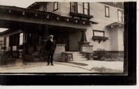 [Doukhobor man standing in front of a building in an unknown location]