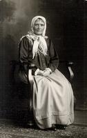 [Portrait of a Doukhobor woman sitting in a chair in an unknown location]