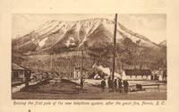 Raising the first pole of the new telephone system, after the great fire, Fernie, B.C.