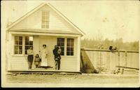 [Family on front porch of a building in Chase, B.C.]