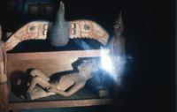 Wood carving of a shaman's tomb
