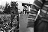 A Time To Change Exhibition. Photo 09 by Craig Berggold. Field worker has her daily ‘piece-rate’ card punched by labour contractor during Brussels spout harvest. Aldergrove, BC, November 1983.