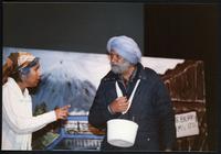Vancouver Sath Picket Line Tour, Fraser Valley, BC, 1988. Actor Makhan Tut as a seasonal berry picker listens to actress Anju Hundal about the dangers of pesticides in Vancouver Sath's play 'A Crop of Posion' .