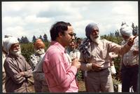 Canadian Farmworkers Union President Raj Chouhan speaks to farm workers in the Fraser Valley fields.