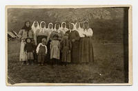 [Photographic postcard of Doukhobor women and children outside, c. 1910s]