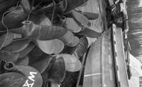 [Close up view of numerous boat propellers]