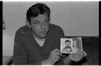 Tom Kozar with pictures of his father killed 8 days before Tom's birth