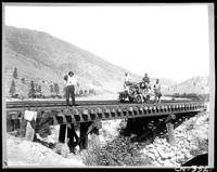 C.P.R. wooden bridge over 5 Mile Creek at M.183, Thompson subdivision - Indian men, small boy and speeder on tracks