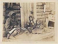 Mother and two children working with moosehide