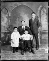 Studio portrait of 2 Chinese men, and 2 children